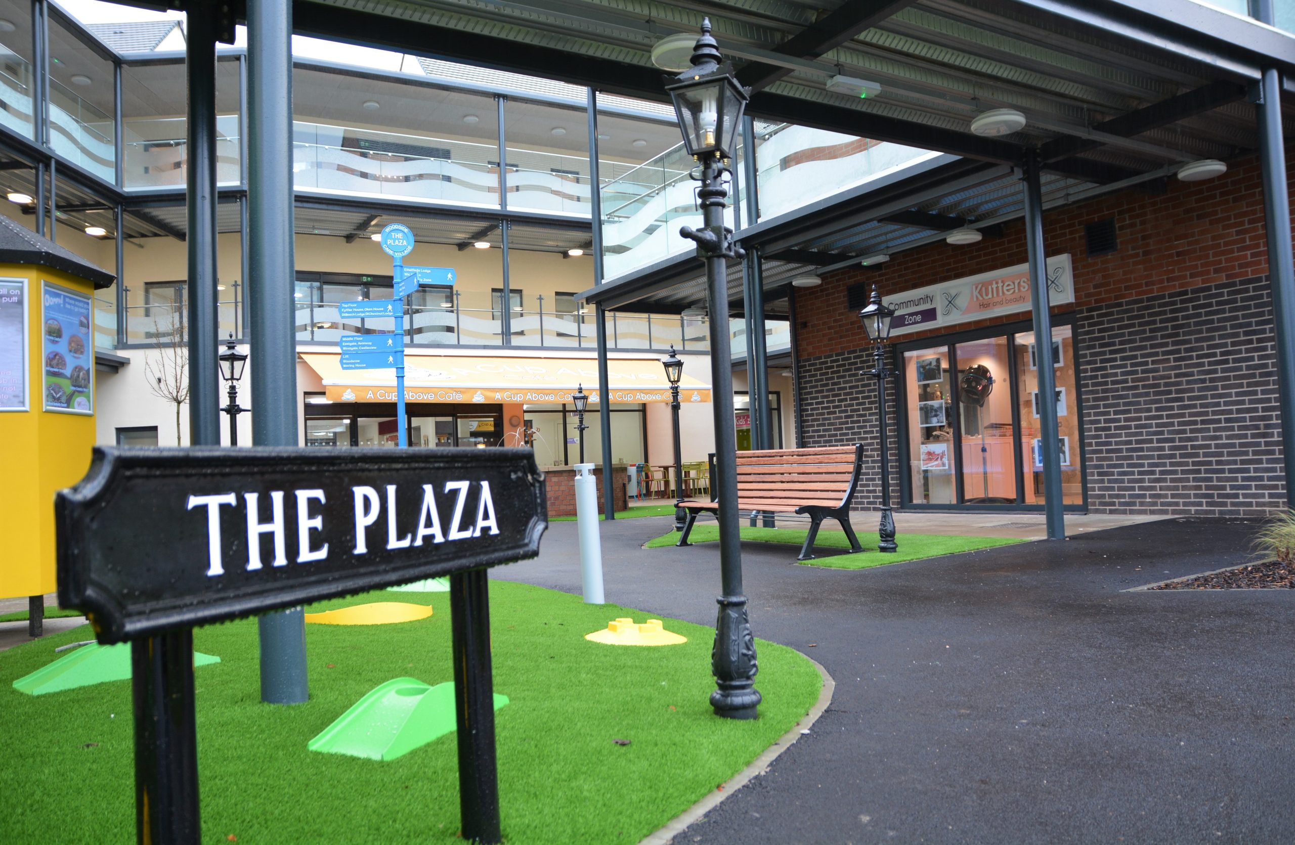 Care village with multiple floors and a road sign that reads "the plaza"