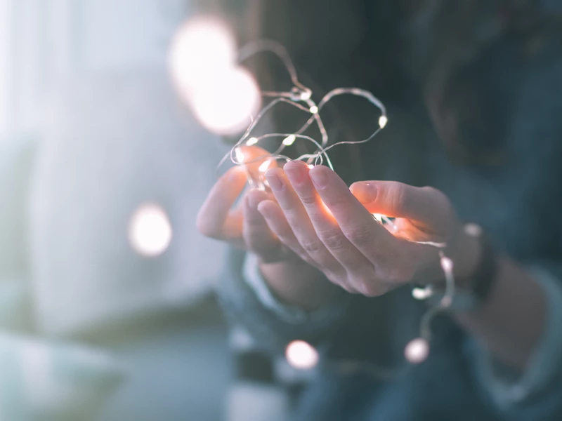 Person holding a bundle of fairy lights