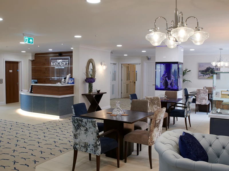 Lobby of Baycroft Care Home showing dining tables and reception desk
